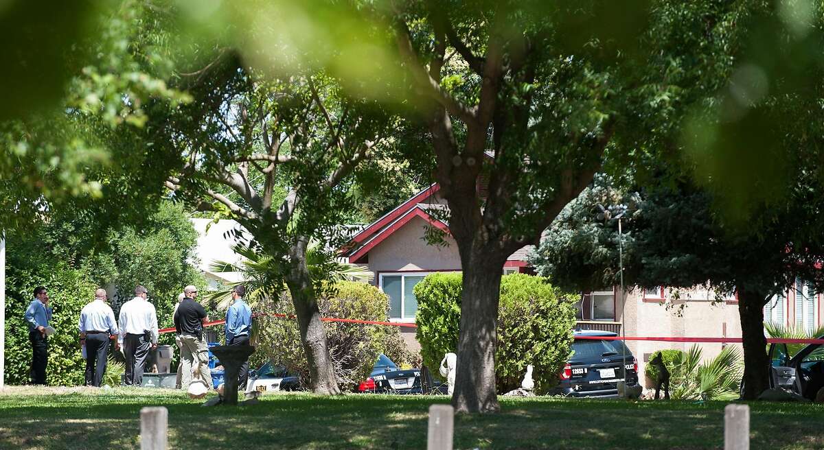 Crime scene investigators approach the Redwood Avenue home where a Sacramento Police Department officer was shot on June 19, 2019 while assisting a woman in collecting her belongings to escape an abusive relationship.