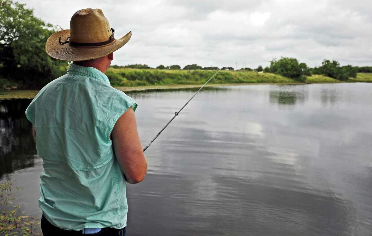 With the stock tank’s dam in the background, Zane Goodspeed reels in a lure in hopes of helping the landowner reduce the population of largemouth bass.
