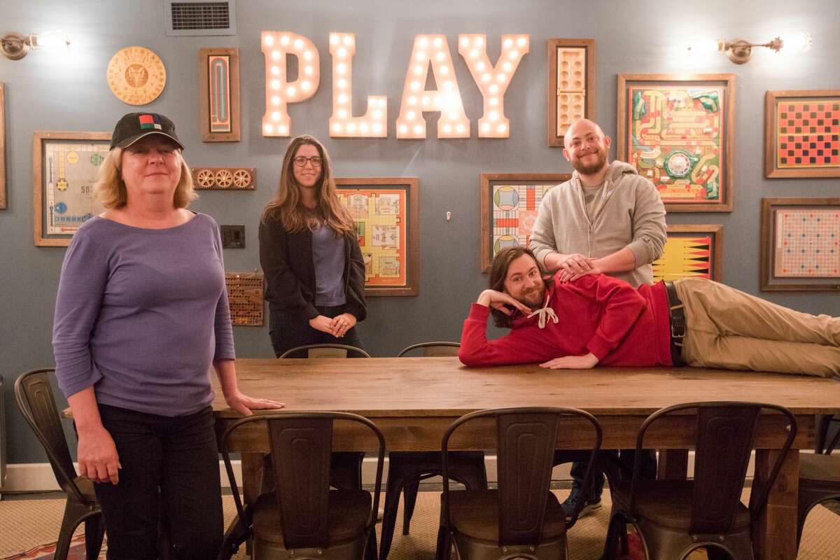 (Left to right) Maggie Ziomek, Allie Jordan, Andrew Holmgren (on table) and Greg Gettle work at Palace Games. Located at the Palace of Fine Arts in San Francisco, Palace Games has three popular escape rooms that attract fans from all around the world.