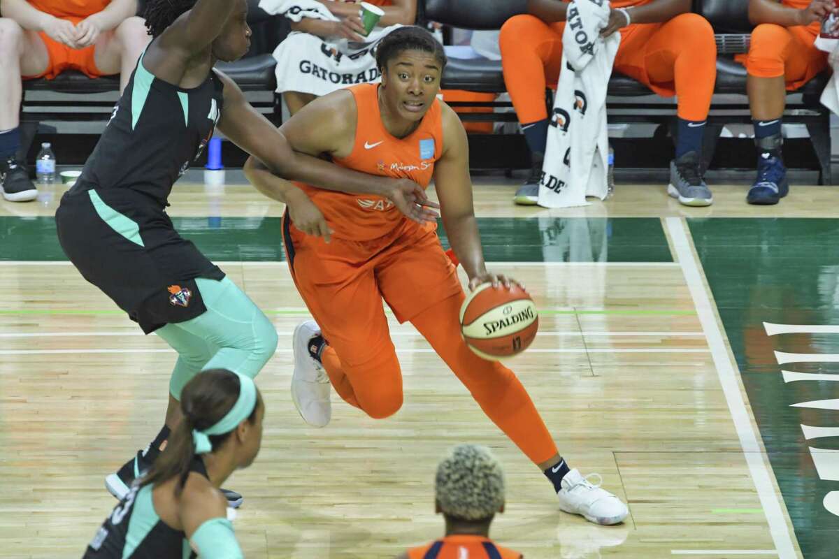 The Connecticut Sun’s Morgan Tuck drives around a New York Liberty defender in a May 19 preseason game.