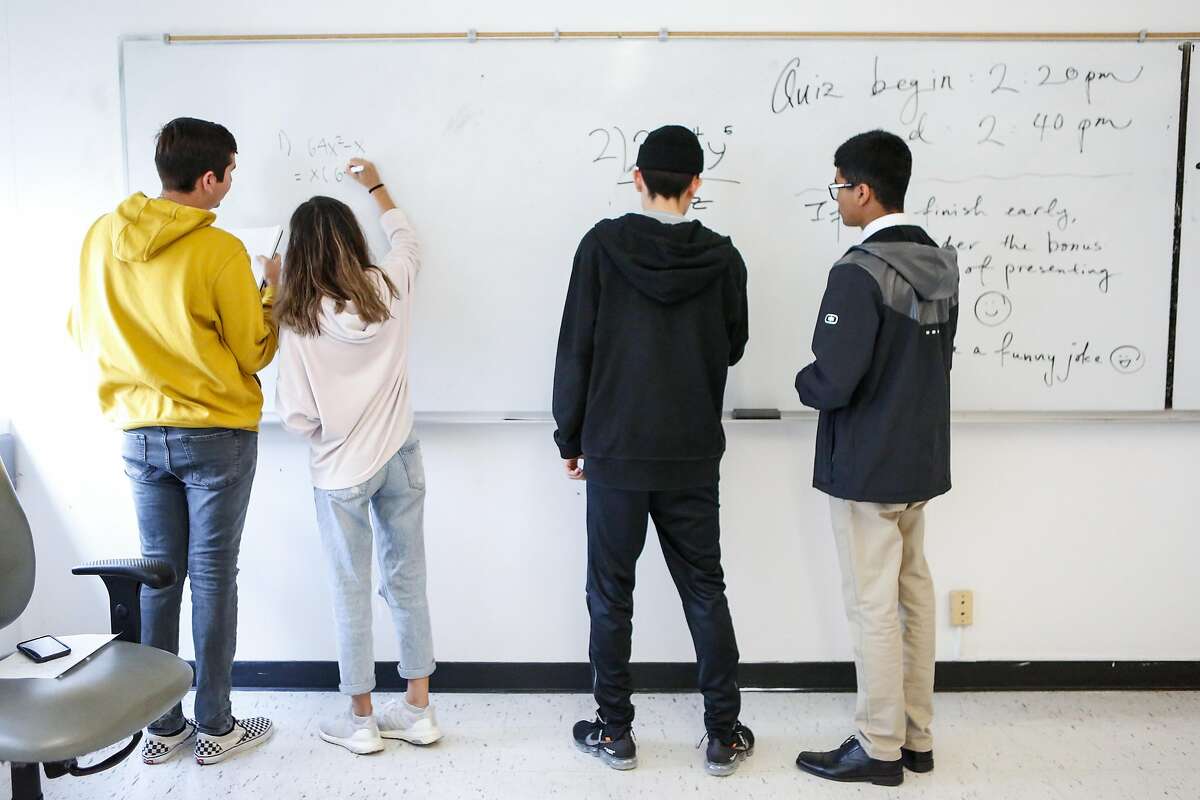 Students work through equations on the white board during a Business Calculus class at SFSU on Monday, September 17, 2018 in San Francisco, Calif.