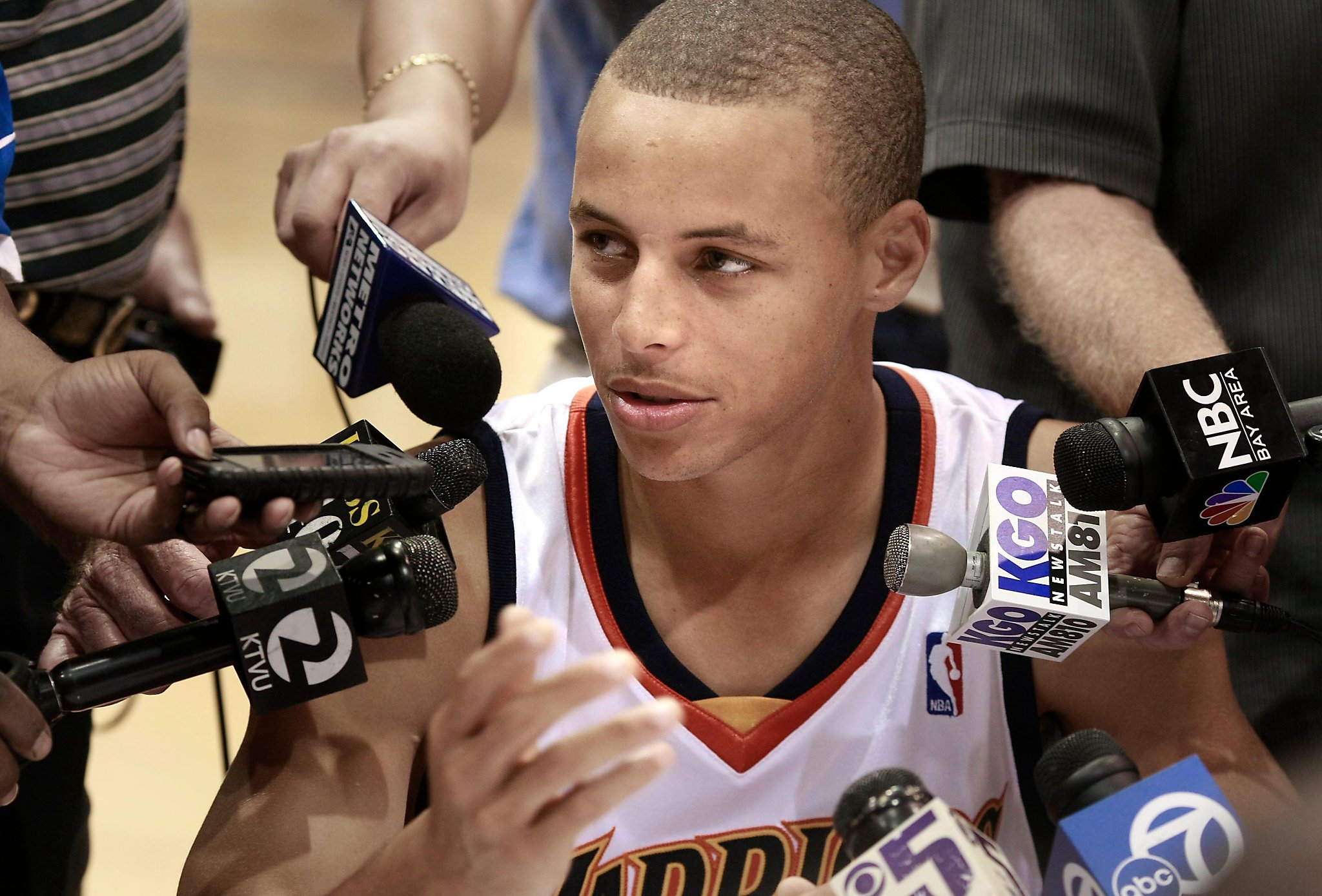 Golden State Warriors top draft pick Stephen Curry poses with his new  jersey during a news conference at the Warriors headquarters in Oakland,  Calif., Friday, June 26, 2009. Curry, a guard from