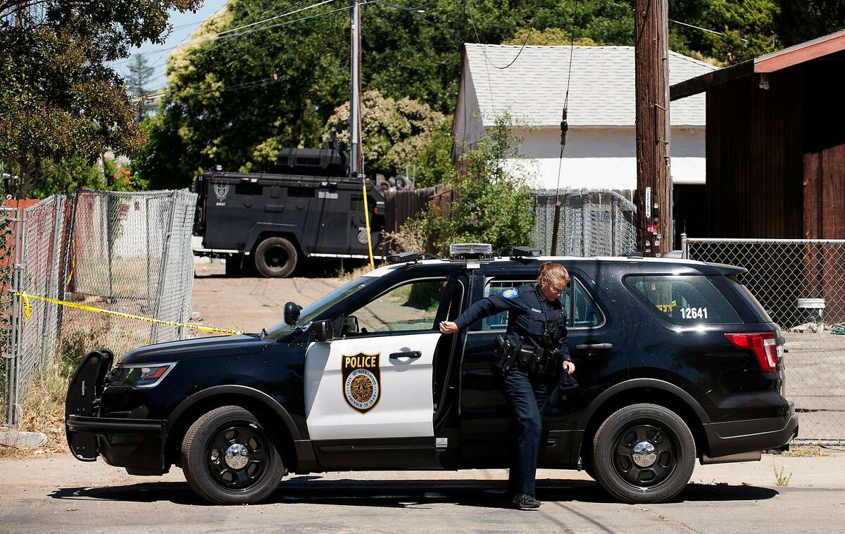 A Sacramento police department bearcat sits in the alley behind a house where a fatal shooting of an office took place Wednesday night. 