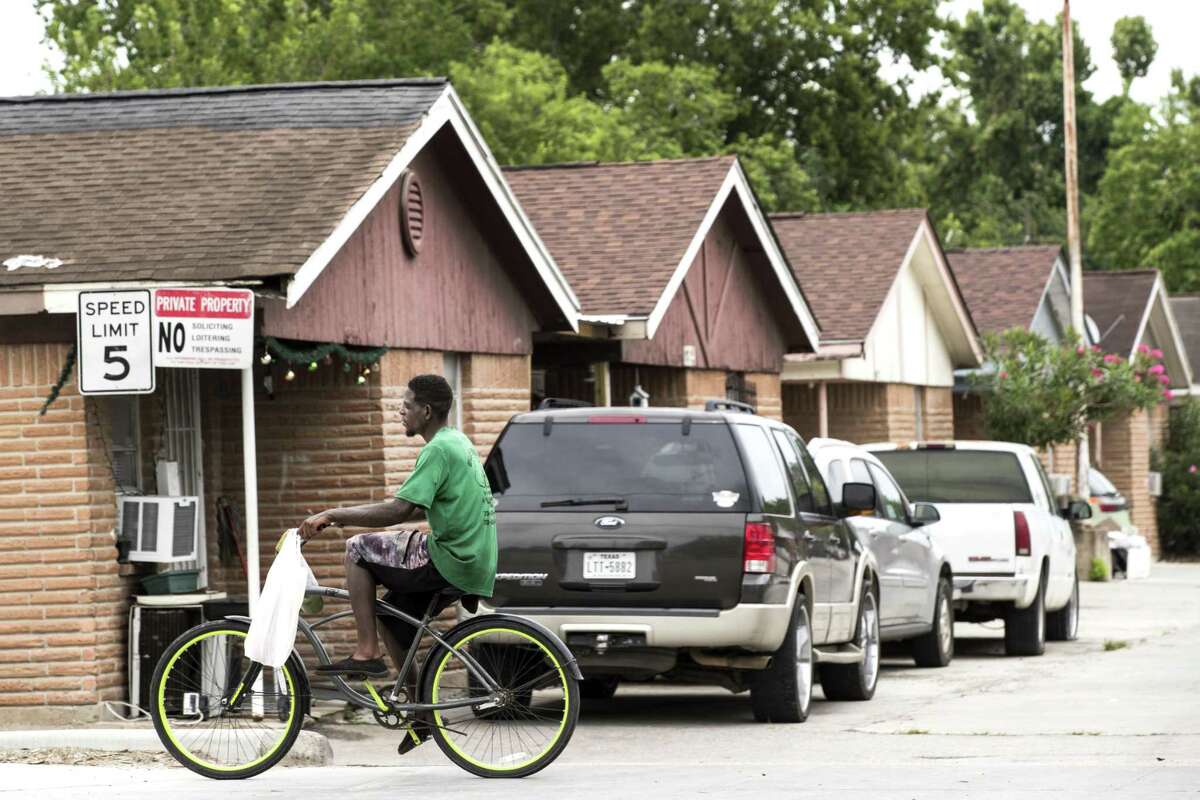 A cyclist ride past a line of homes in the Kashmere Gardens neighborhood on Thursday, June 20, 2019, in Houston. Mayor Sylvester Turner announced more neighborhoods as part of his Complete Communities initiative, including Sunnyside, Kashmere Gardens, Magnolia Park, Alief and Fort Bend Houston.