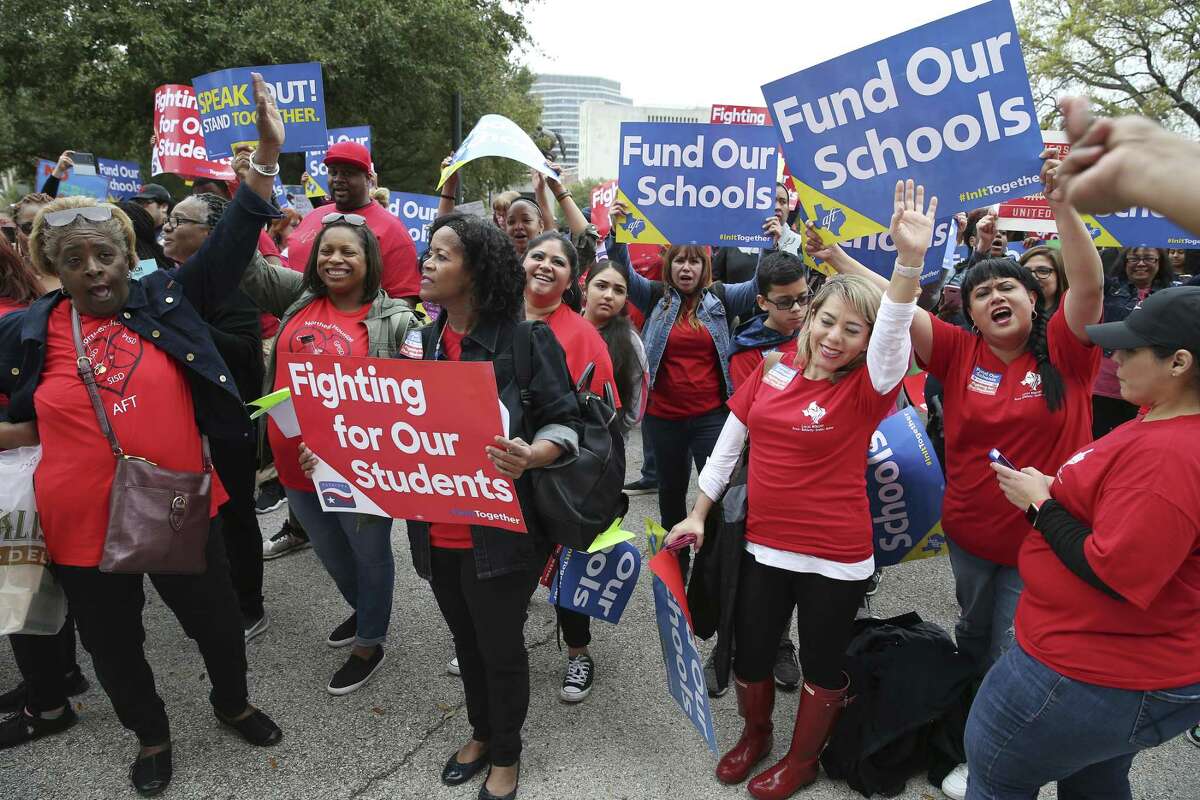 Members of the Northeast Houston American Federation of Teachers, left, and Pharr-San Juan-Alamo American Federation of Teachers, cheer during a rally at the State Capitol in Austin, Texas, Monday, March 11, 2019. A large crowd gathered at the capitol to urge the Texas Legislature for public school funding.