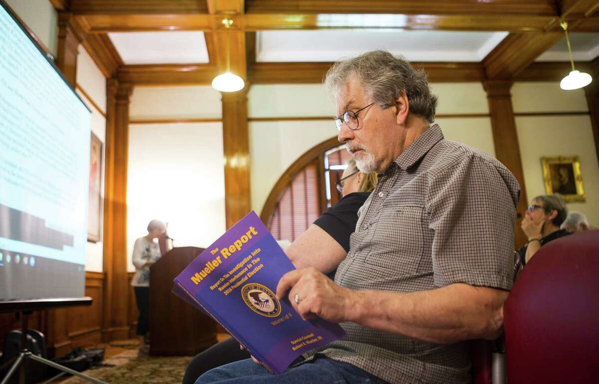 Marc Guilbert reads along during the second day of a four-day-long reading of the Mueller Report by the group Public Reads - Galveston inside the Rosenberg Library in Galveston, Thursday, June 20, 2019.