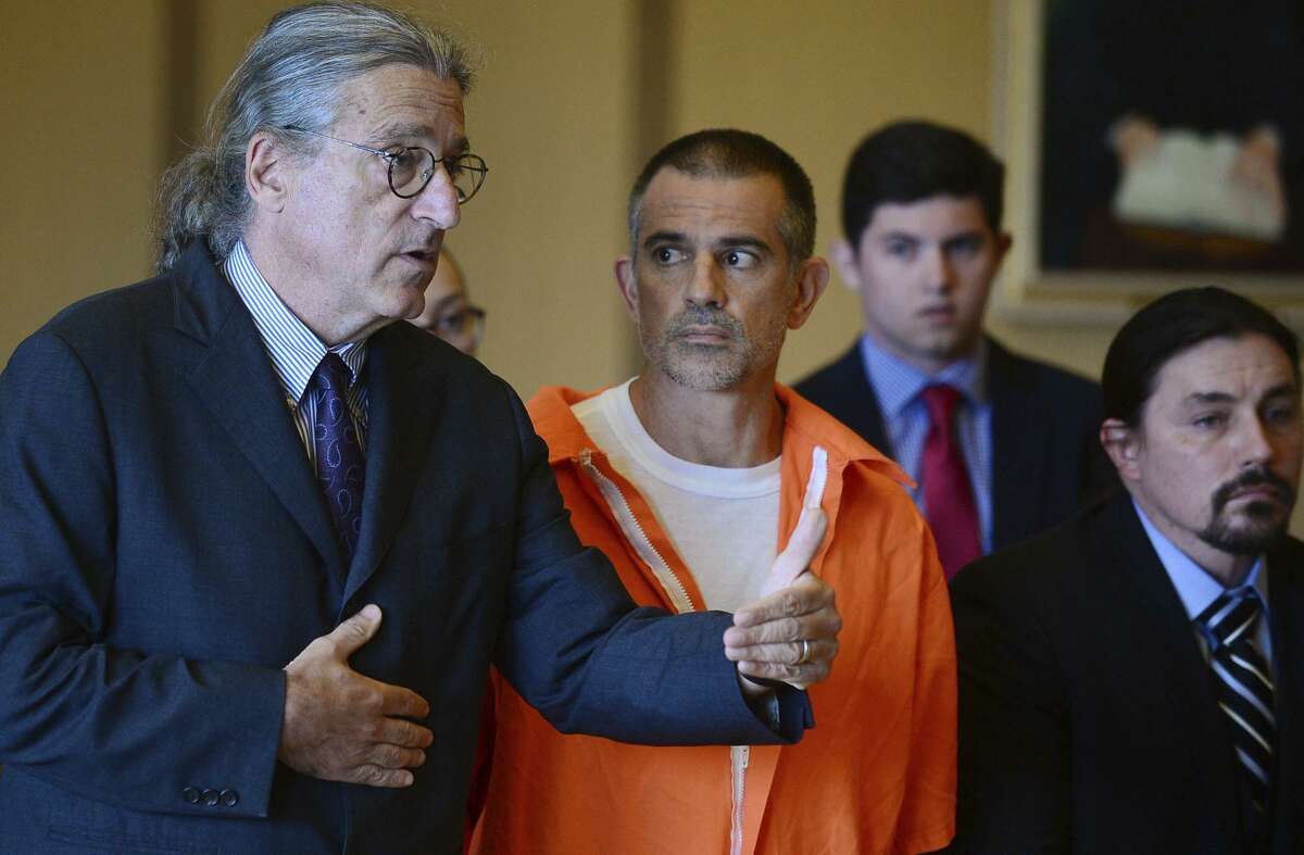 Fotis Dulos, center, listens, as his attorney Norm Pattis, left, addresses the court during a hearing at Stamford Superior Court, Tuesday, June 11, 2019 in Stamford, Conn. Fotis Dulos, and his girlfriend, Michelle Troconis, have been charged with evidence tampering and hindering prosecution in the disappearance of his wife Jennifer Dulos. The mother of five has has been missing since May 24.