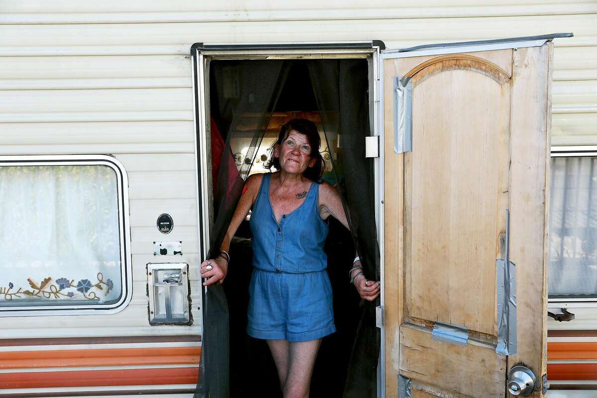 Eileen Mulcahy, 57, stands in her RV near 85th Ave. and Baldwin St. in Oakland, Calif., on Thursday, June 20, 2019. "There are so many abandoned buildings and abandoned warehouses that could be like given to us ... to get us off the streets and maybe to empower us, to be able to say, 'Okay, this could be ours.'" Mulcahy said. "Millions of dollars was allocated for the homeless. A little bit went to the tuff sheds, that's like concentration camps to me because you're being watched."