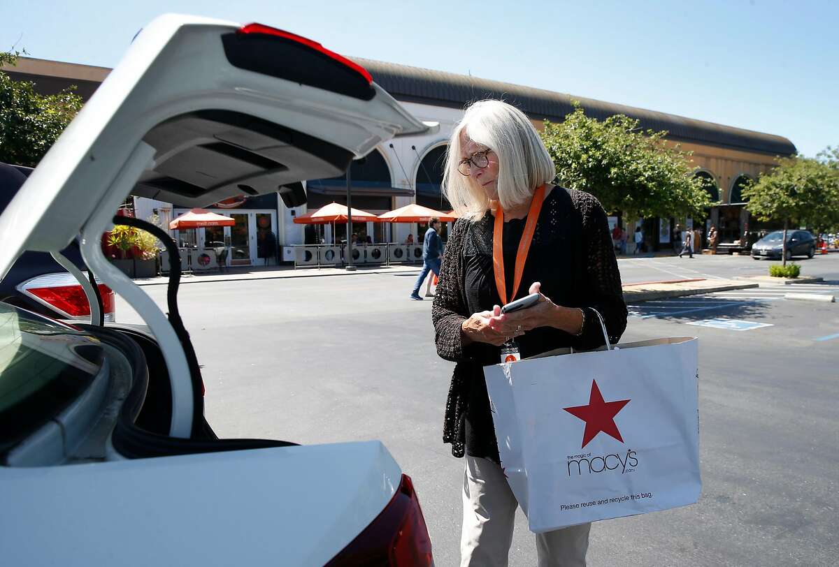 Lynne Richardson, a driver for deliv.co, picks up merchandise at Stanford Shopping Center ordered through the Macy�s website before personally delivering the items to a customer in Menlo Park, Calif. on Friday, June 21, 2019.