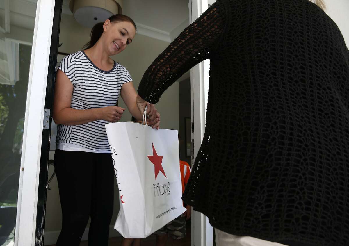 Jennifer Tayebi accepts a delivery of merchandise from deliv.co driver Lynne Richardson in Menlo Park, Calif. on Friday, June 21, 2019.