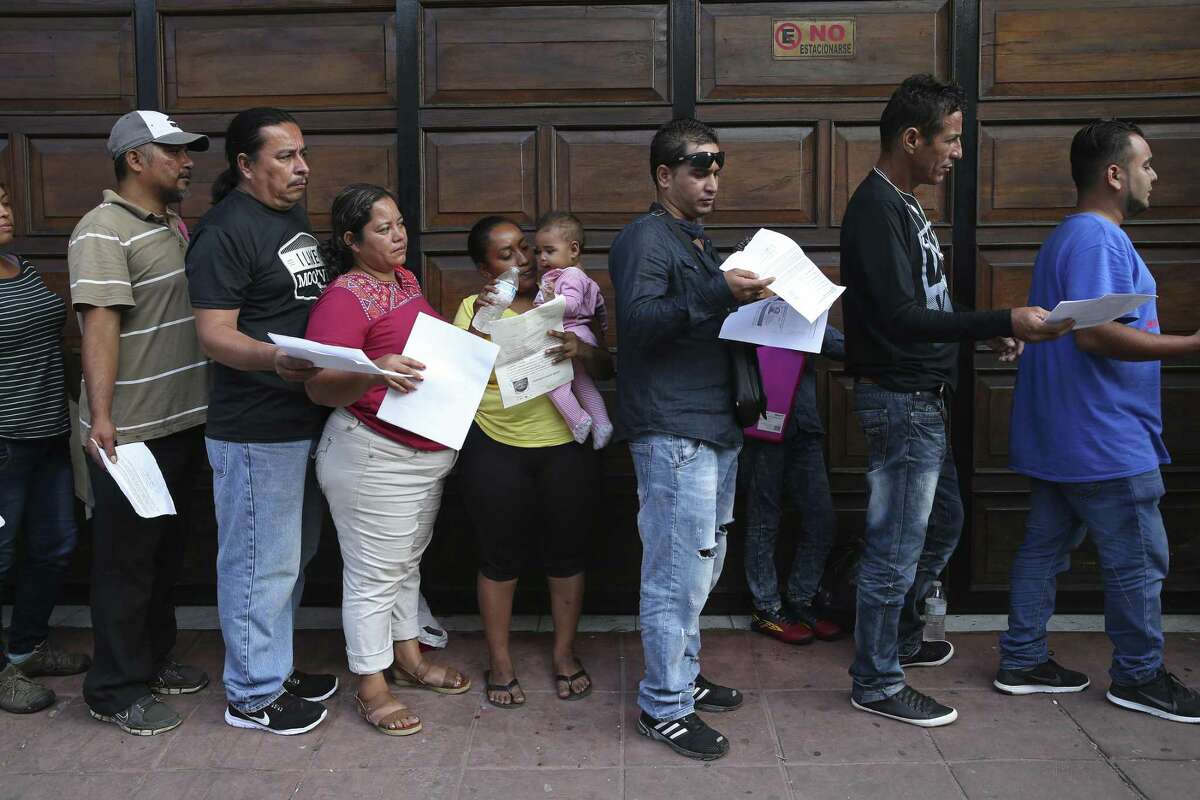 Migrants line up early for an opportunity to secure an appointment with the Mexican Commission of Assistance to Refugees, (COMAR), in Tapachula, Mexico, Monday, June 17, 2019. Officials handed pieces of paper with a time and date indicating their appointment to plea their case for a humanitarian visa. The visa allows them to stay in the country without the fear of getting deported. Tapachula is in the state of Chiapas and is about 10 miles from the border with Guatemala.
