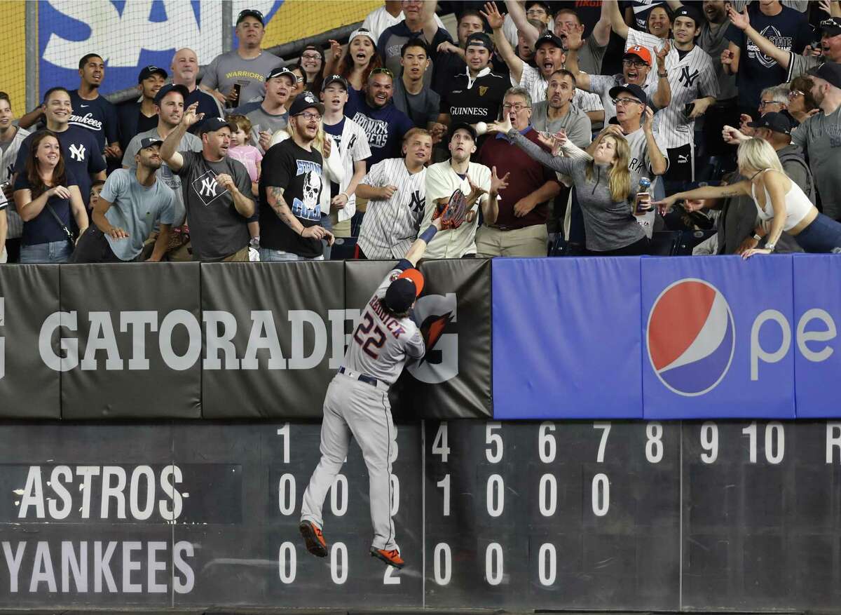 Astros right fielder Josh Reddick can't quite reach a two-run homer off the bat of the Yankees' Gleyber Torres in the seventh inning Friday night.
