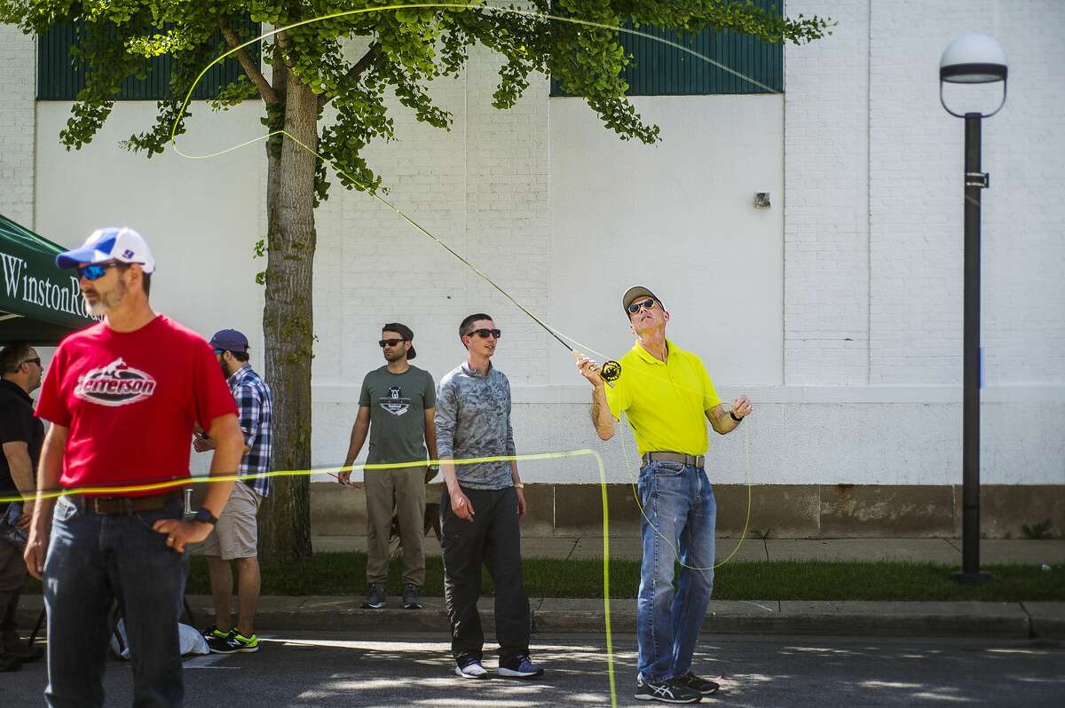 Bob Hobohm of Midland tries out a fly fishing rod during the second annual Outlandish fest on Friday, June 21, 2019 in downtown Midland. (Katy Kildee/kkildee@mdn.net)