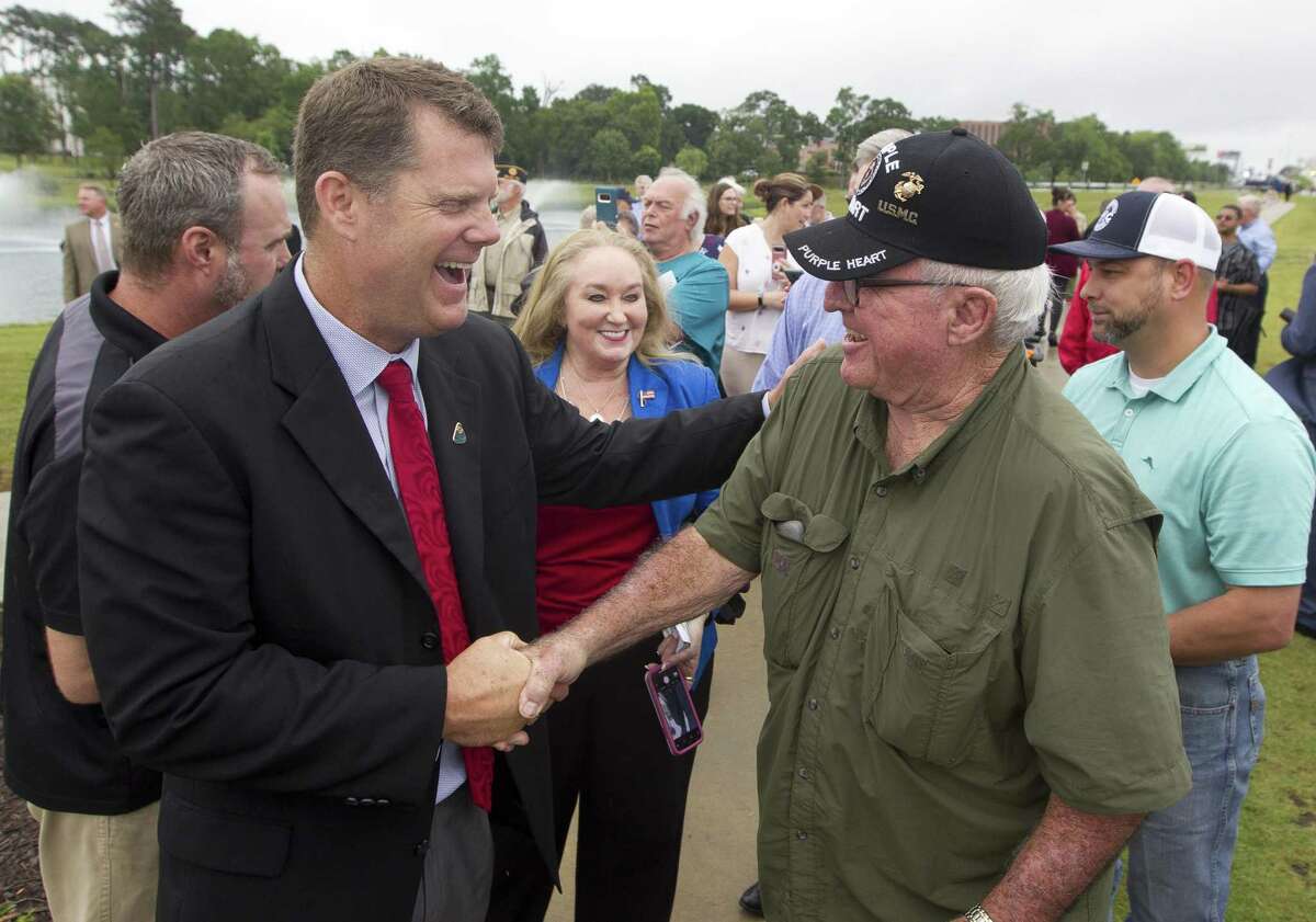 Conroe Noon Lions Club current President Bobby Brennan jokes with retired United States Marine Corps Cpl. Jimmie Edwards III during the dedication of the Montgomery County Veterans Memorial Monument, Wednesday, June 5, 2019, in Conroe.