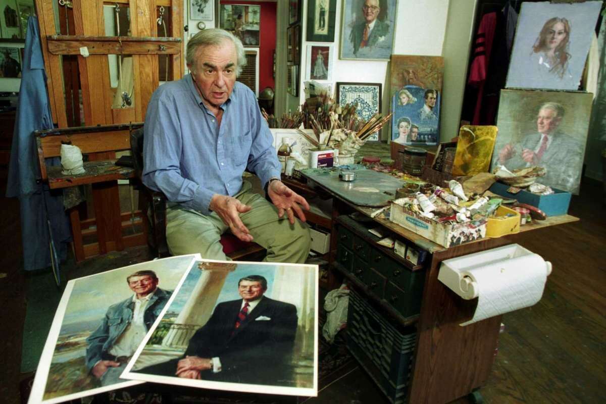 Artist Everett Raymond Kinstler talks in his Easton studio about President Ronald Reagan. Kinstler painted the official White House portrait of President Reagan. A copy of that portrait can be seen in the foreground, along with a copy of another Kinstler painting of Reagan that hangs in the Cowboy Hall of Fame in Oklahoma.