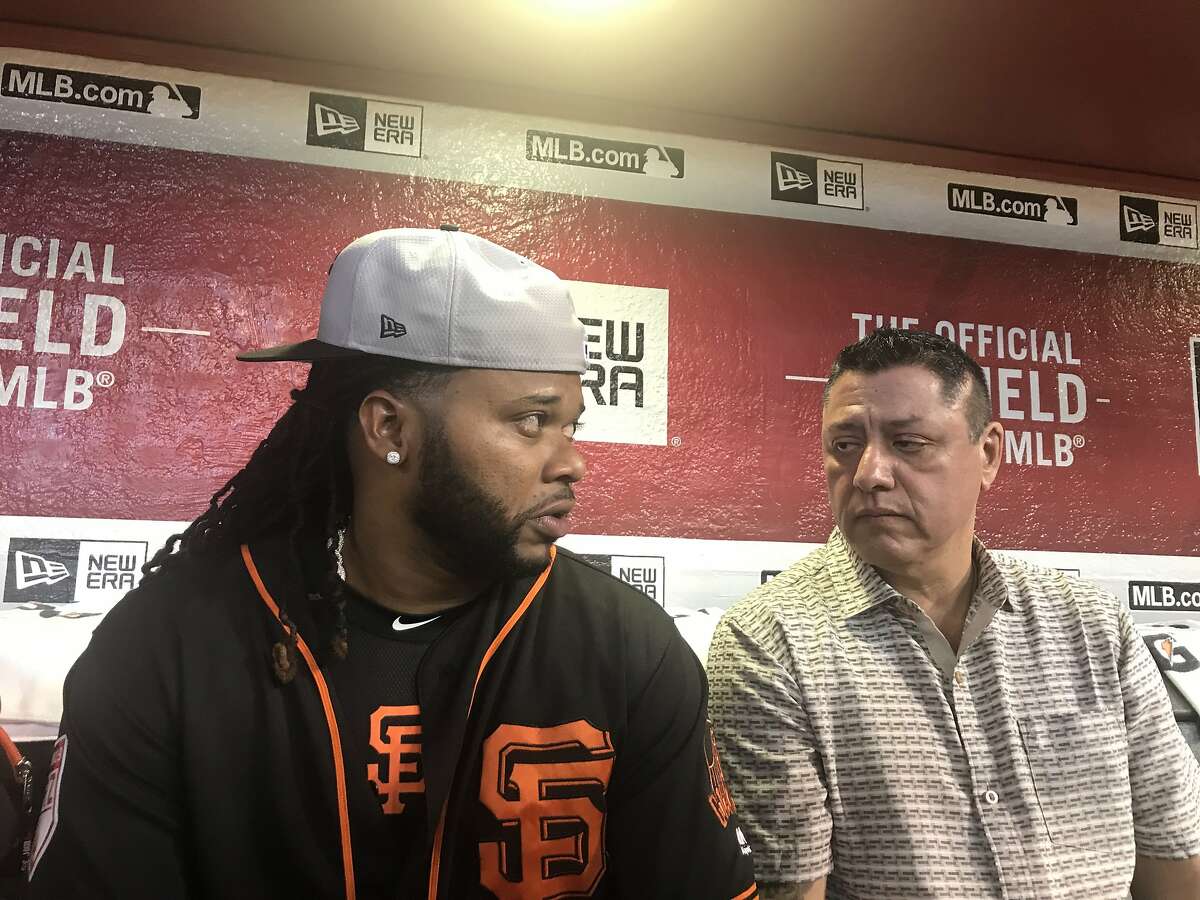 San Francisco Giants pitcher Johnny Cueto in the dugout at Chase Field in Pheonix with translator Erwin Higueros.