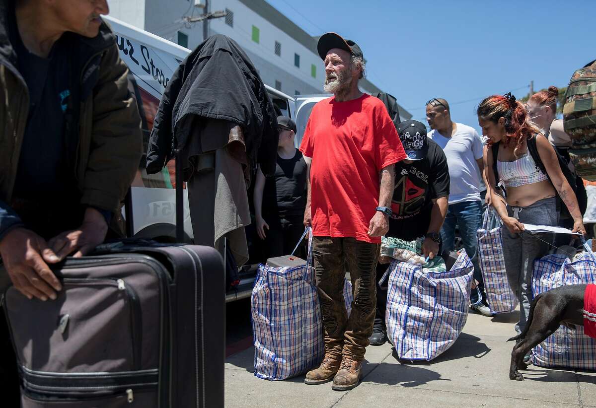 Unhoused resident David Chaplin joins others in receiving a care package during a protest highlighting San Francisco Department of Public Works' controversial practice of street sweeping and property confiscation held outside of San Francisco Department of Public Works yard in San Francisco, Calif. Friday, June 21, 2019.