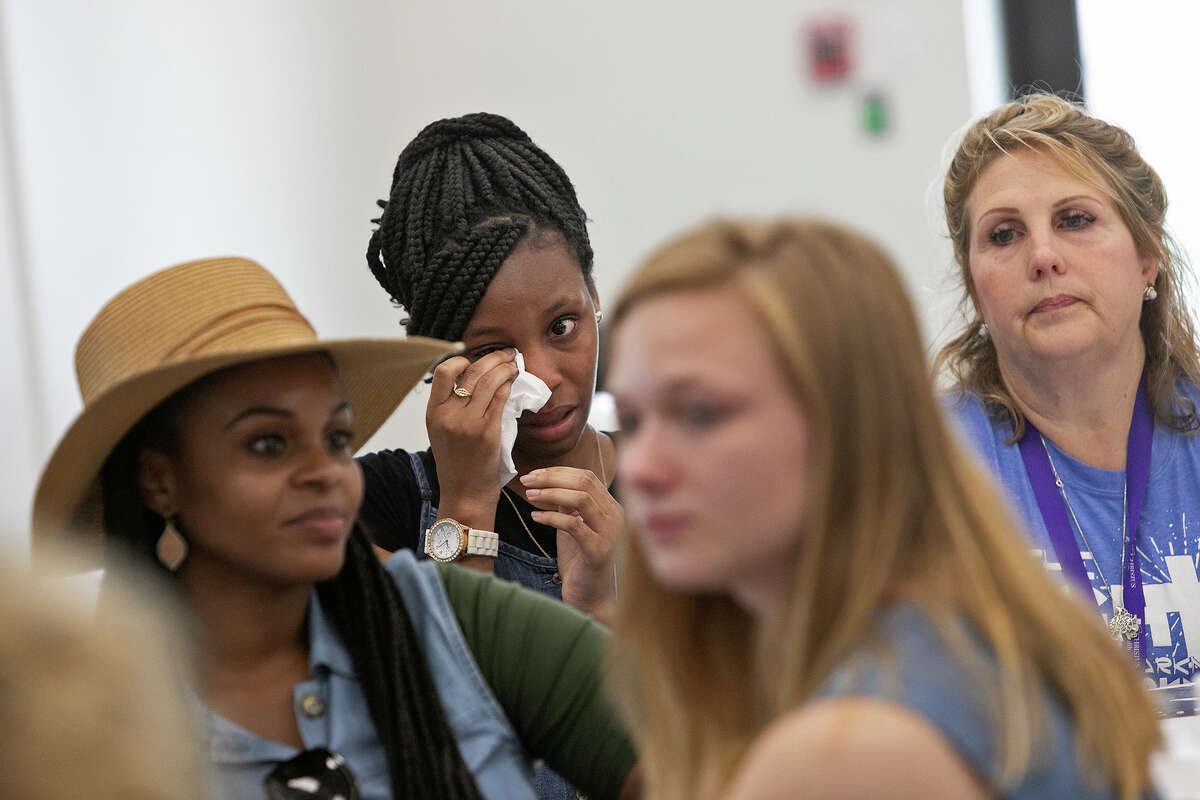 Santa Fe High School shooting surivor Jai Gillard, 16, wipes tears after she read the poem, "Faith and Strength," she wrote for survivors at First Baptist Church of Sutherland Springs on Saturday, June 22, 2019. Seated are also Gillard's mother, Deidra Perry, from left, Santa Fe High School shooting survivor Annabelle O'Day, and First Baptist Church of Sutherland Springs shooting survivor Julie Workman.