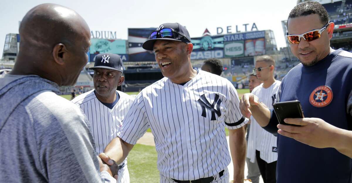 Former New York Yankees player Mariano Rivera, center, greets people on the field during Old Timers' Day at Yankee Stadium, Sunday, June 23, 2019, in New York. (AP Photo/Seth Wenig)