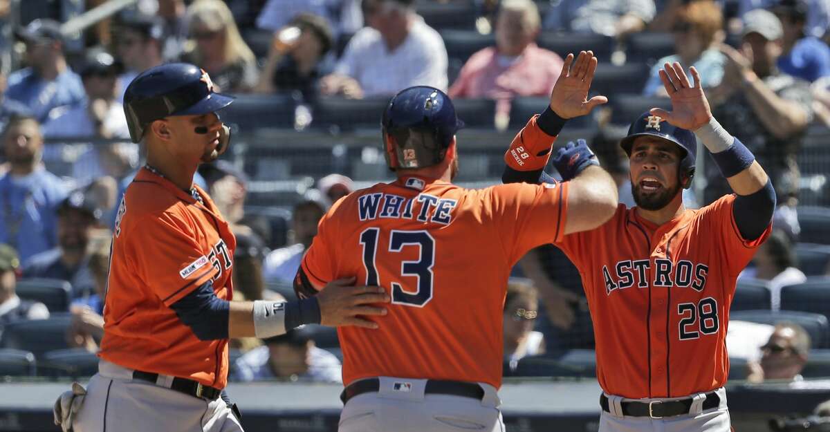 Houston Astros' Robinson Chirinos, right, and Yuli Gurriel, left, celebrate Tyler White's (13) grand slam during the fourth inning of a baseball game against the New York Yankees at Yankee Stadium, Sunday, June 23, 2019, in New York. (AP Photo/Seth Wenig)