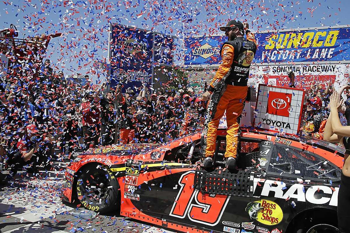 Martin Truex Jr. celebrates after winning a NASCAR Sprint Cup Series auto race in June 2019.