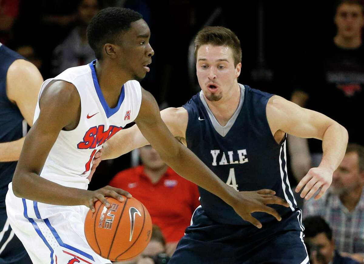 SMU guard Shake Milton (1) moves the ball around the perimeter as Yale's Jack Montague (4) defends during an NCAA college basketball game, Sunday, Nov. 22, 2015, in Dallas. (AP Photo/Tony Gutierrez)