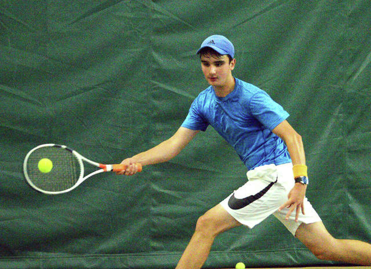 Michael Karibian reaches for a shot during his match against Colton Hulme on Sunday in the boys’ 14 singles final of the Tiger Classic at the Edwardsville Meyer Center YMCA.