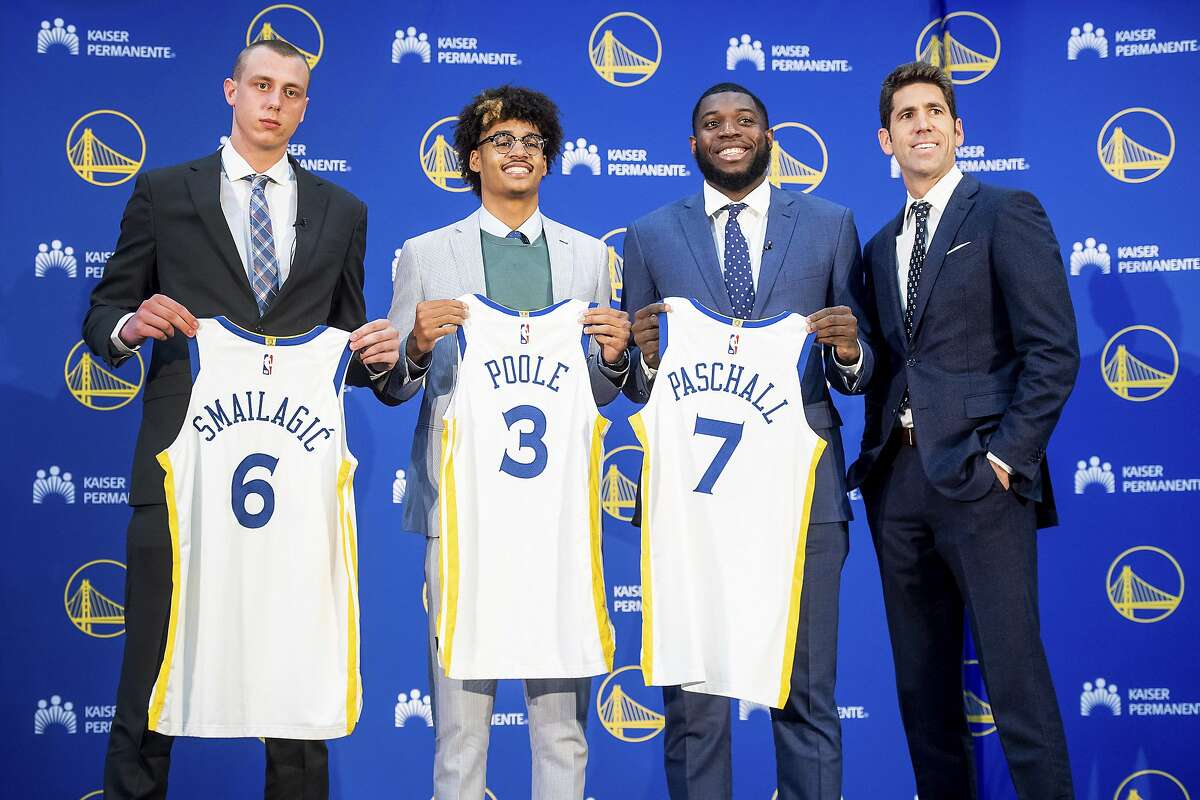 The young guns: Golden State Warriors NBA basketball general manager Bob Myers, right, stands with draft picks Eric Paschall, Jordan Poole and Alen Smailagic.