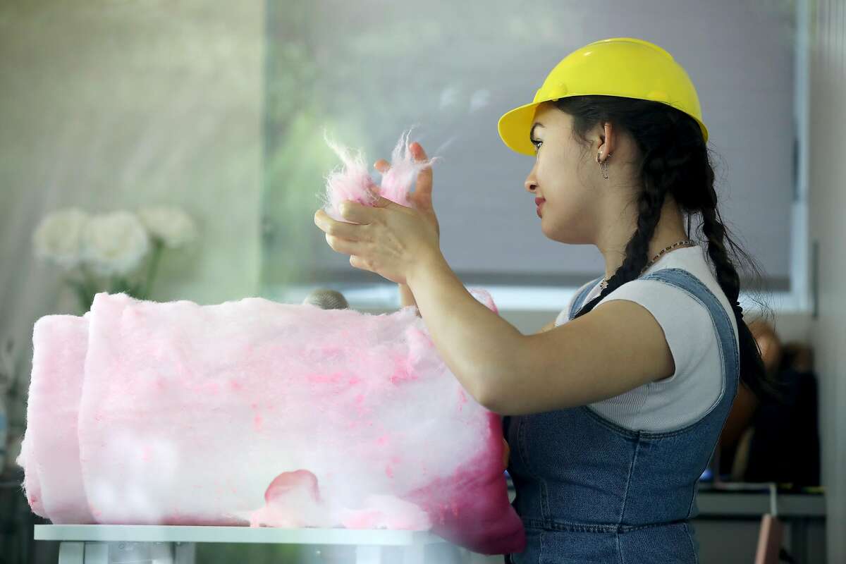 ASMR artist Eve Donnelly, 17, shoots a video in her studio where she pretends to eat insulation, but she's strategically placed pieces of cotton candy away from the camera, in Palo Alto, Calif., on Tuesday, May 21, 2019. Donnelly has been shooting the ASMR (autonomous sensory meridian response) videos since December. "So, I go under the guise of someone who's doing ASMR, but then once you actually see my videos you're like, 'Whoa, this is quite different than regular ASMR I would see.' My whole schtick is like eating things that aren't edible," Donnelly said. "I guess my motivation is I want to get, like, a reaction out of people."