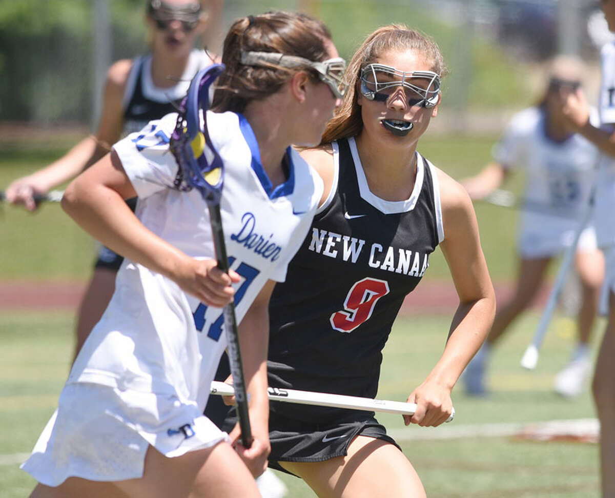New Canaan senior co-captain Katelyn Sparks (9) defends against Darien’s Sarah Jaques (17) during the CIAC Class L girls lacrosse final at Jonathan Law High School in Milford on Saturday, June 8, 2019. — Dave Stewart/Hearst Connecticut Media