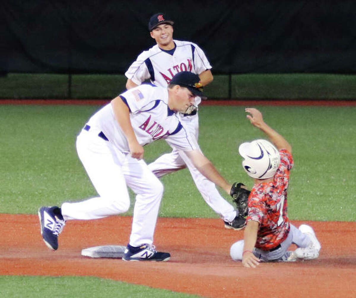 Alton second baseman Gage Booten tags out a runner attempting to steal.