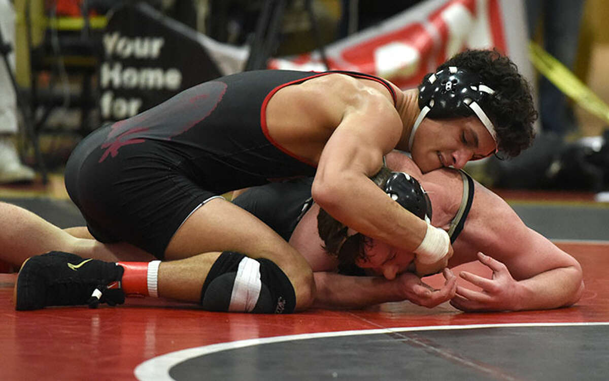 Tyler Sung controls Trumbull's Matt Ryan en route to a 5-1 victory in the 138-pound final during the FCIAC wrestling championships at NCHS last winter. — Dave Stewart photo