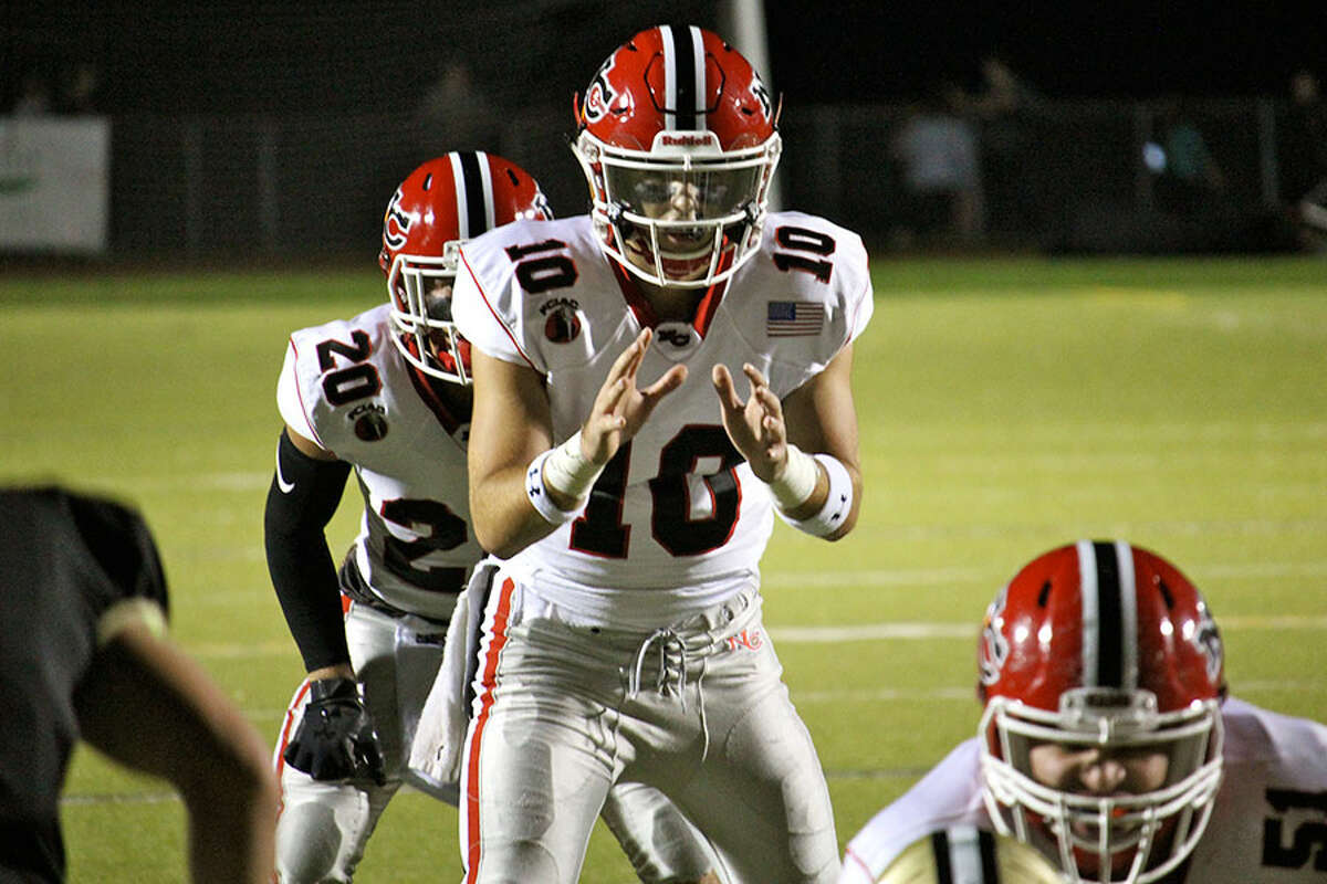 New Canaan quarterback calls out the play during the Rams' 48-7 win over the Eagles in Trumbull on Friday night. — Terry Dinan photo