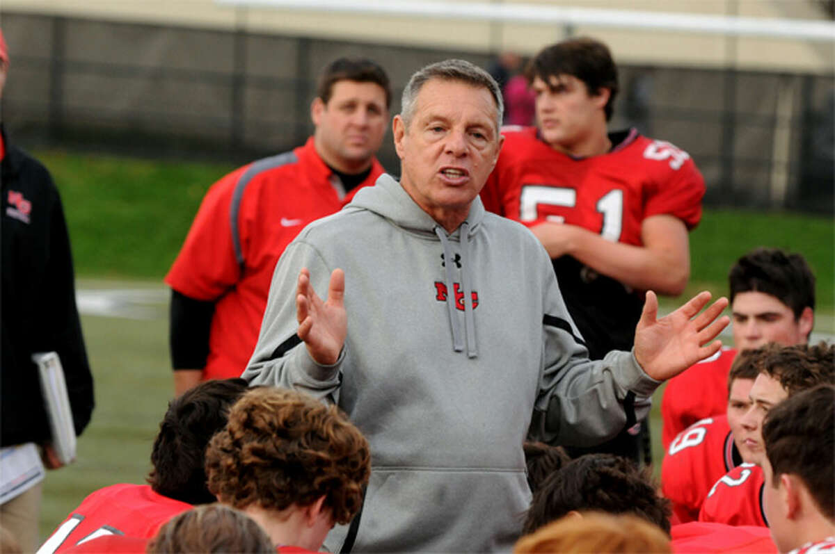 New Canaan football head coach Lou Marinelli speaks to his team following a Ram victory at Dunning Field. Photo: Dave Stewart/Hearst Connecticut Media