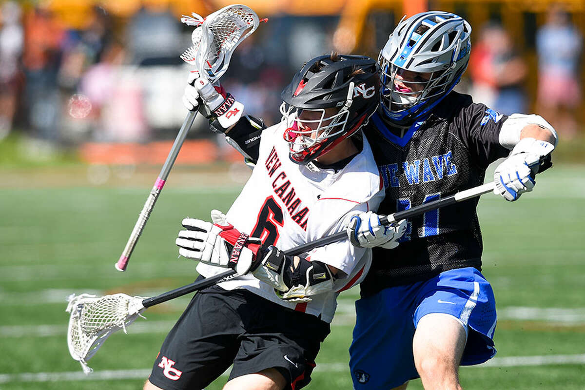 New Canaan's Teddy Manges (6) battles Darien's Pierce Hoyda (41) in a boys lacrosse game at Dunning Field on Saturday. — Matthew Brown/Hearst Connecticut Media