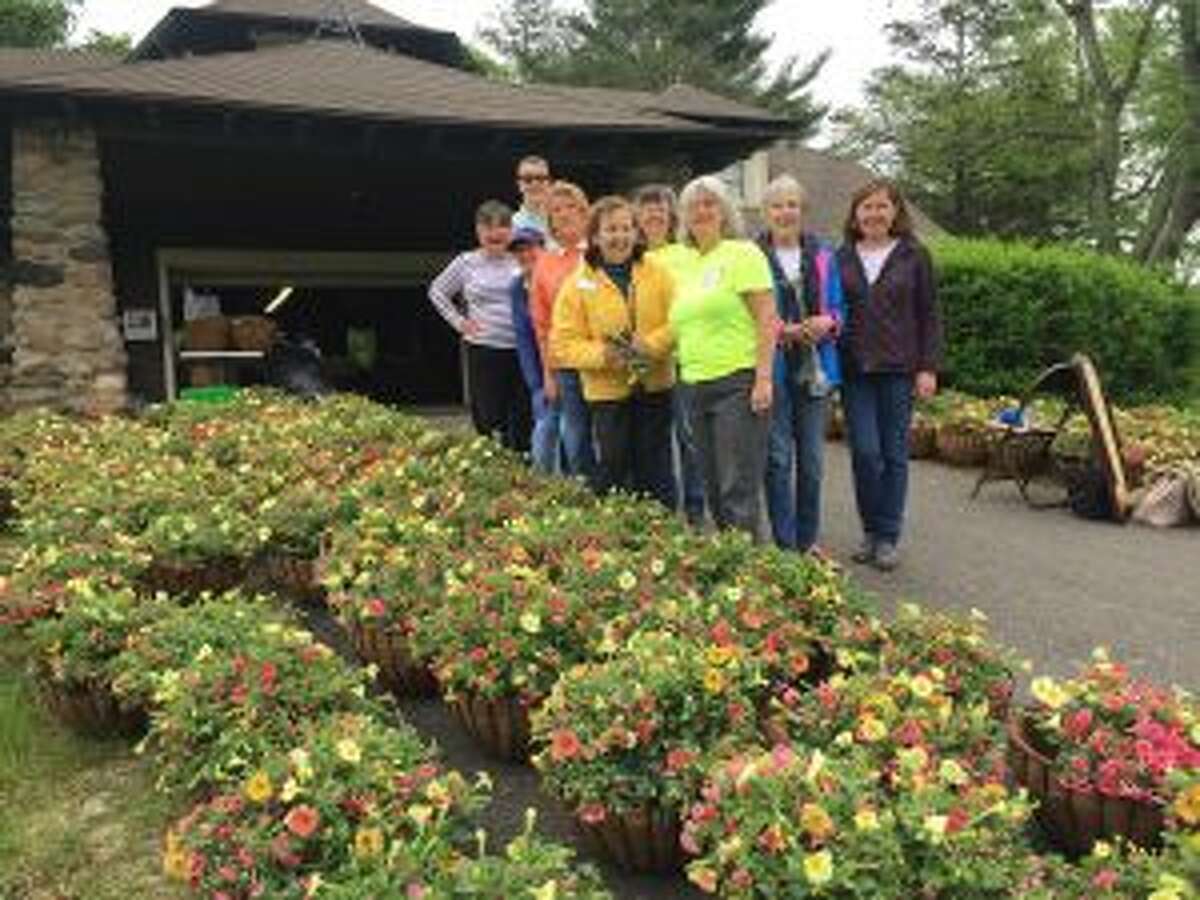 New Canaan Beautification League members at Irwin Park preparing hanging baskets to be displayed around the downtown village. — Contributed photo