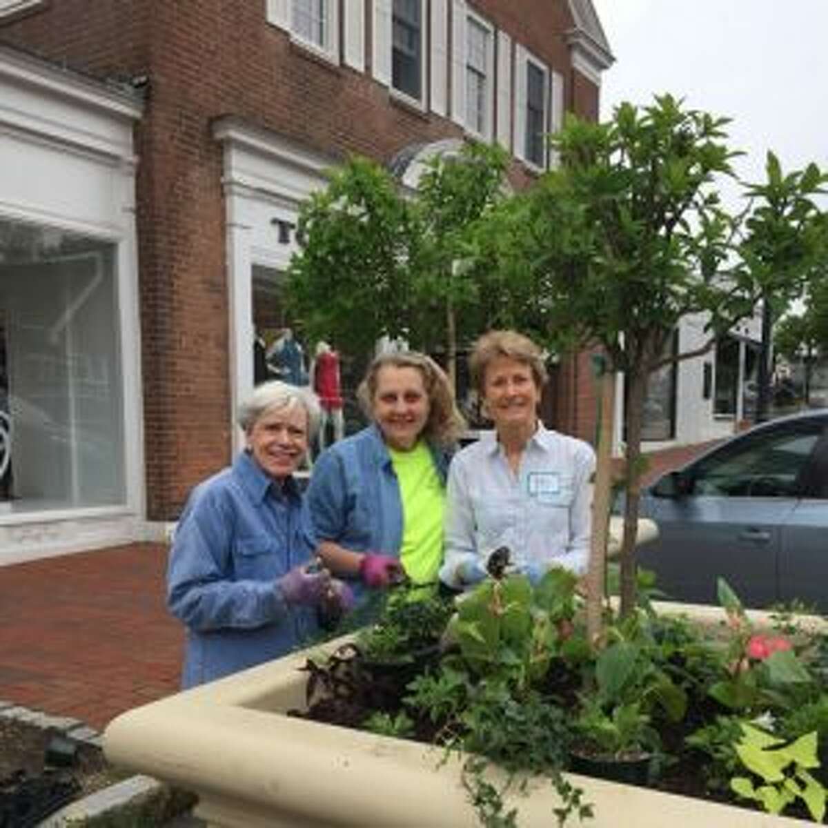 From left Beautification League members Gerta Smith, Betsy Sammarco and Betsy Bilus work on a planter in town. - Contributed photo