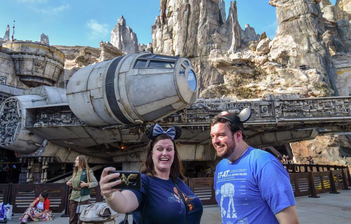 Disney fans take selfies in front of the Millennium Falcon on opening day at Star Wars: Galaxy's Edge at Disneyland in Anaheim, CA, on Friday, May 31, 2019. More photos: See images from behind the scenes of Disneyland's construction >>