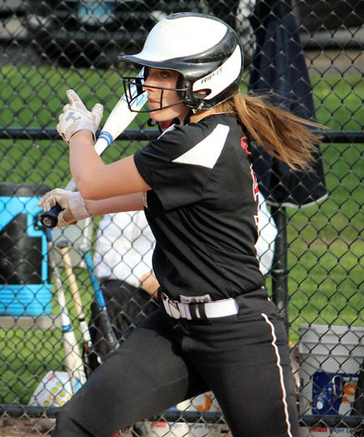 Gillian Kane raps out a hit during Friday's game in Waveny Park. — Terry Dinan photo