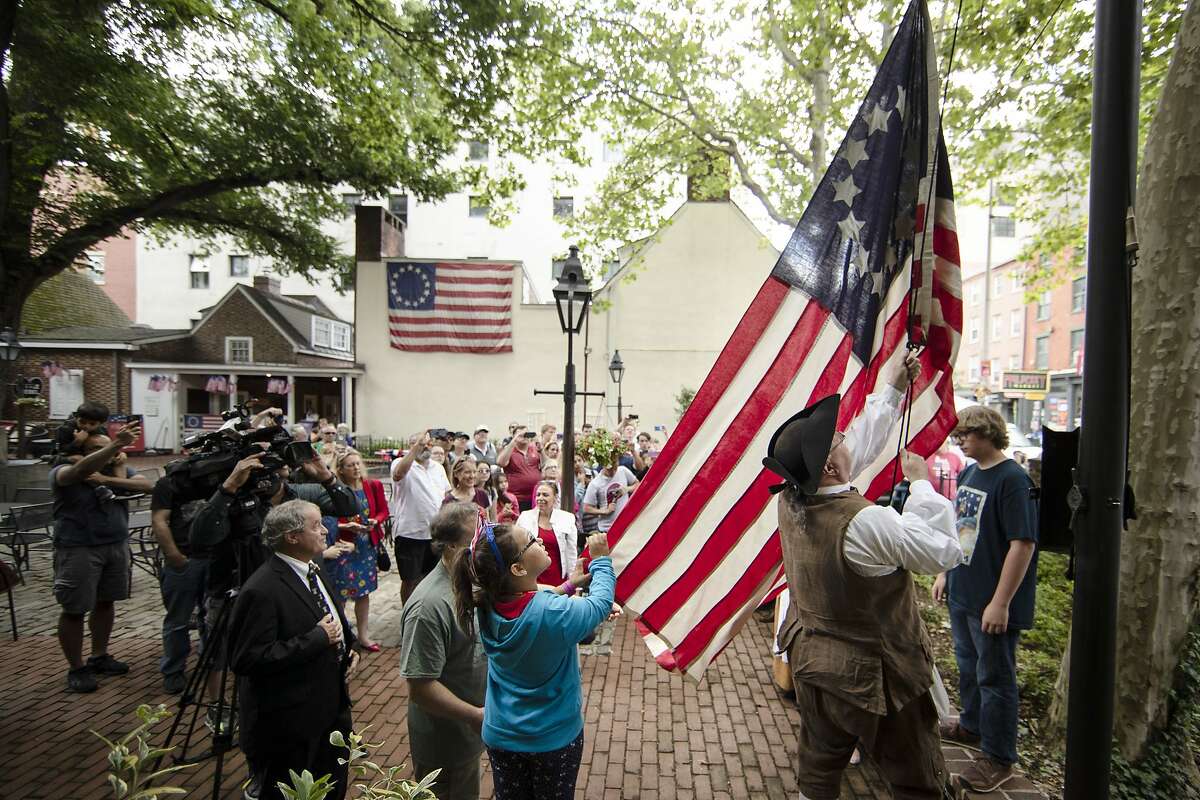 An American flag is hoisted at the Betsy Ross House in Philadelphia, on Flag Day Friday, June 14, 2019. (AP Photo/Matt Rourke)
