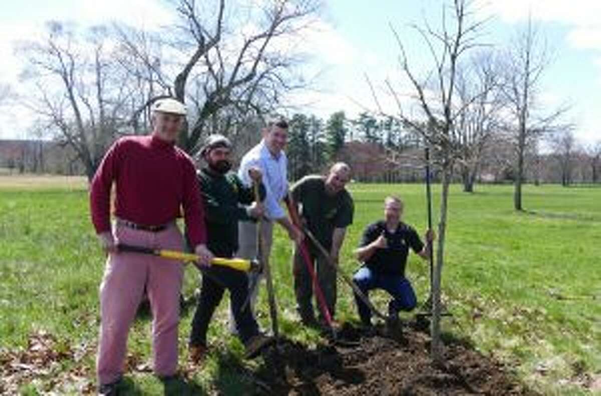 Celebrating planting a tree that was donated to the town by Almstead Tree Co., in Waveny Park are Chris Schipper of Waveny Park Conservancy; Chad Yvon of Almstead; Brock Saxe of Waveny Park Conservancy; Erik Valenzuela of Almstead and Isaac Taylor of Almstead giving a thumbs up. — Grace Duffield photo