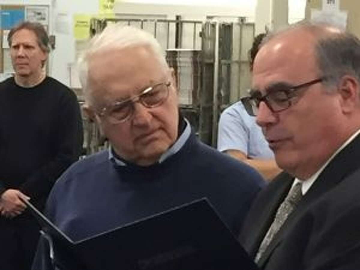 A New Canaan Town letter carrier is marking his 60th year with the United States Postal Service. Connecticut Valley District Manager David Mastroianni Jr. and Anthony Spadaccini are shown at the April 23 celebration. — Contributed photo