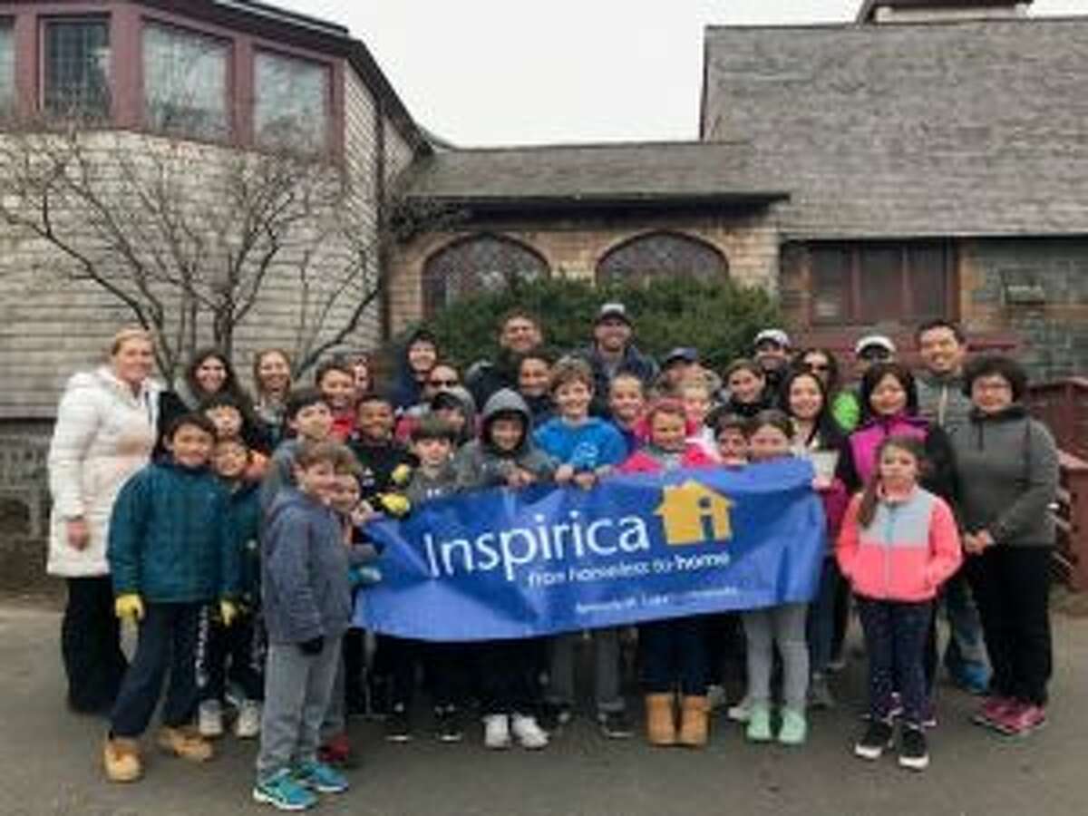 Students, parents, teachers, alumni and friends, holding a banner, are shown at Inspirica in Stamford. — Contributed photo