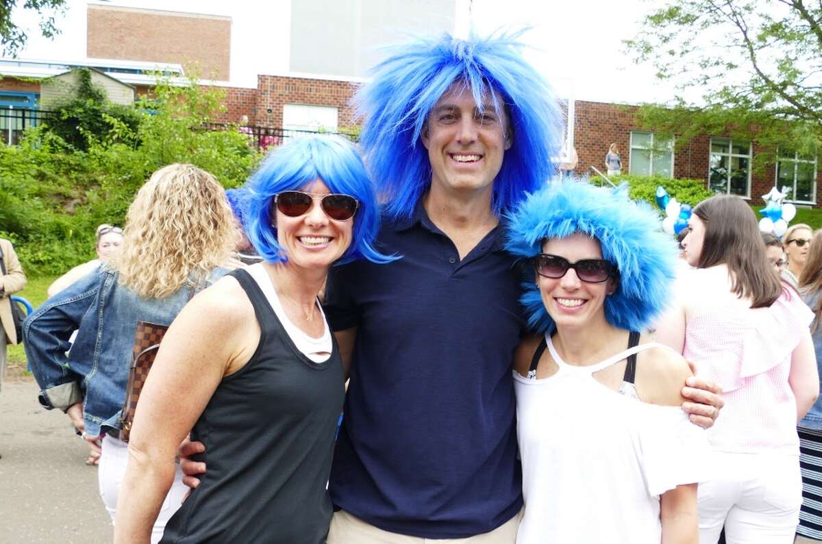 Parents Kelly and Lee Ratner and Christina Smith wore blue wigs in honor of Principal Joanne Rocco who is retiring. — Grace Duffield photos