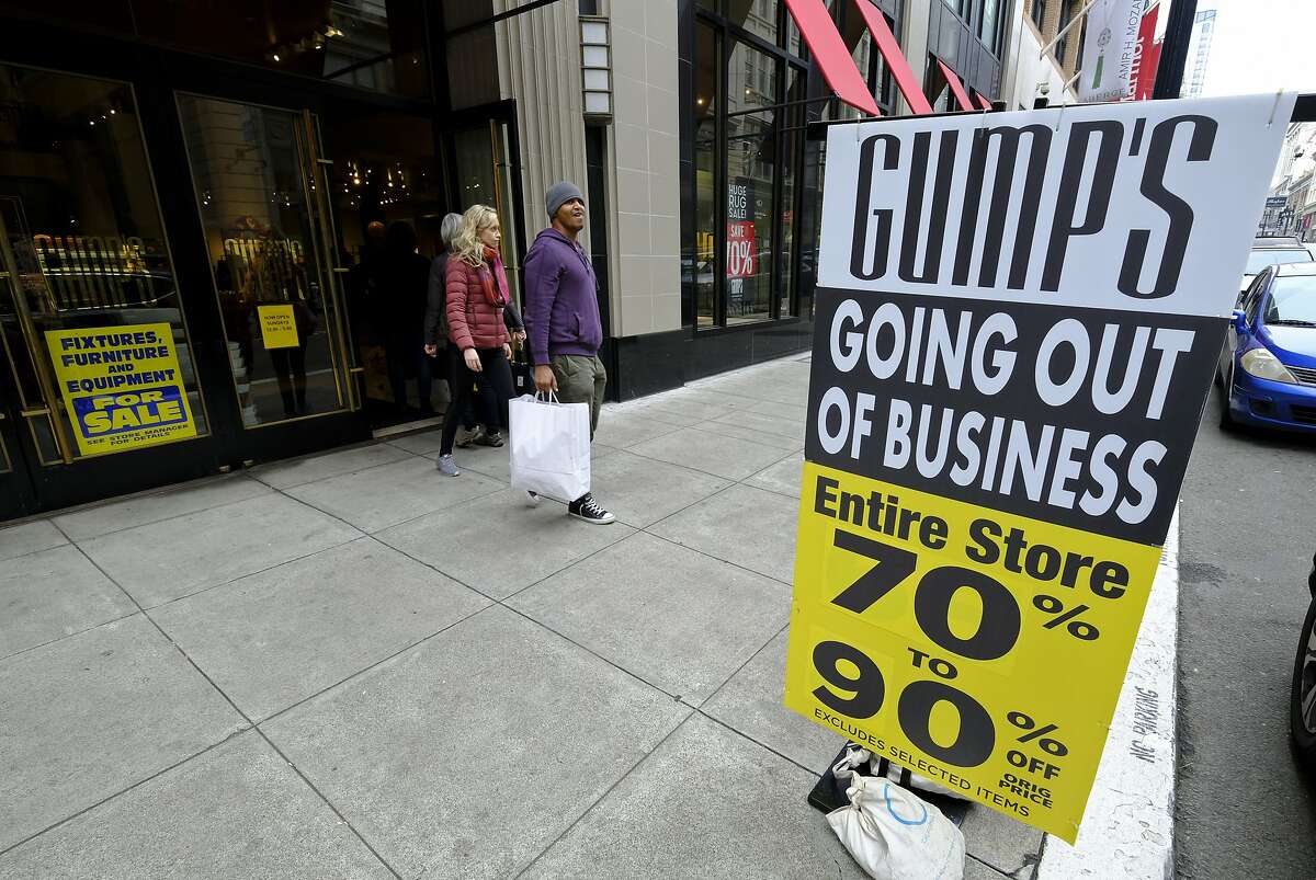 People exit the Gump's store during its liquidation sale Thursday, Dec. 20, 2018, in San Francisco. San Francisco's oldest department store, Gump's, is closing its doors after 157 years in business. Gump's was founded in 1861 as a frame and mirror shop. Its final day of business is Sunday. (AP Photo/Eric Risberg)