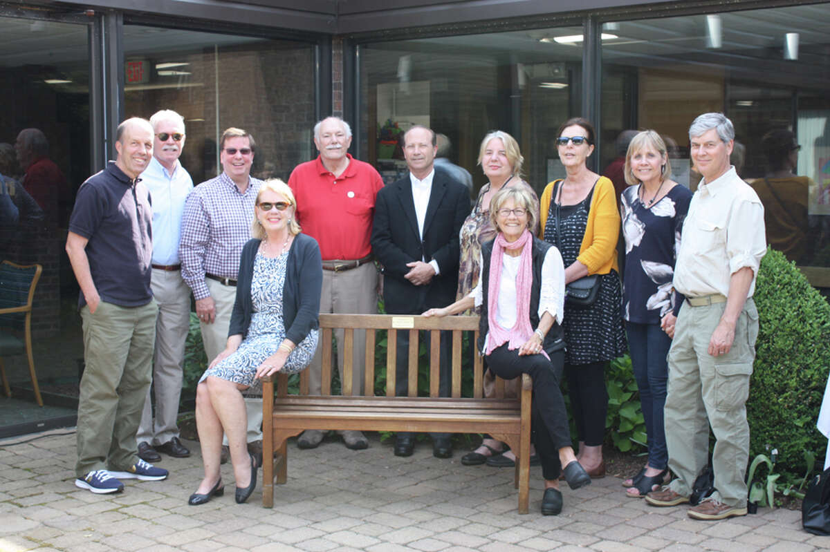 Classmates, friends and family of Peter Lewis celebrate the dedication of a bench at Waveny Care Center in his honor. Contributed photo