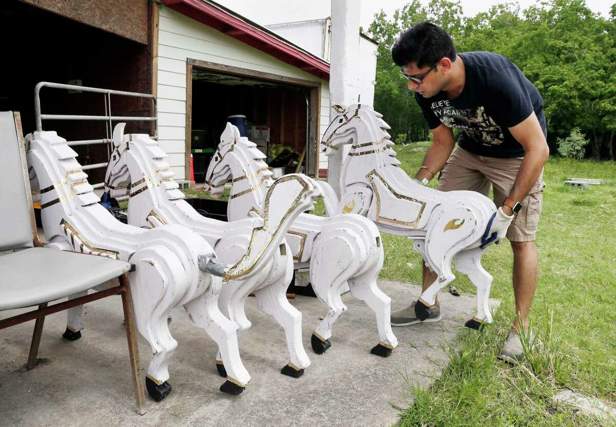 Volunteer and member of the Orissa Culture Center Kunal Panigrahi unpacks horses that are part of a deity chariot from storage. When assembled, the float sized display is pushed on a trailer by volunteers and is being refurbished and painted at the center's property in south Houston Saturday, Jun. 22, 2019, in preparation for the upcoming 12th Annual Hindu Chariot Festival, also known as Rath Jatra. The float was originally designed and built in 2014, and is stored in pieces at the center between the annual chariot festivals.