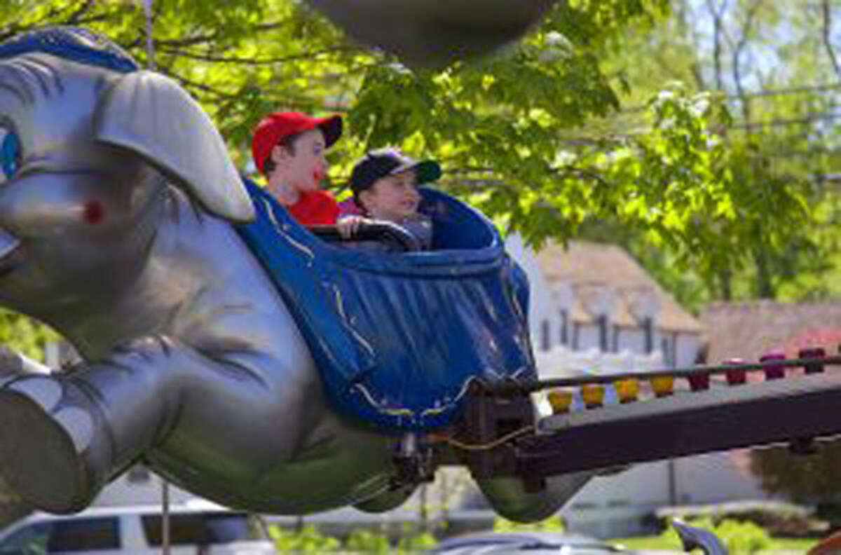 Eamon Gorman, 7, left, of New Canaan, and his brother Rowland, 4, take a spin on the elephant ride during St. Mark's 70th May Fair Saturday, May 11, 2019. Jarret Liotta / For Hearst Connecticut Media