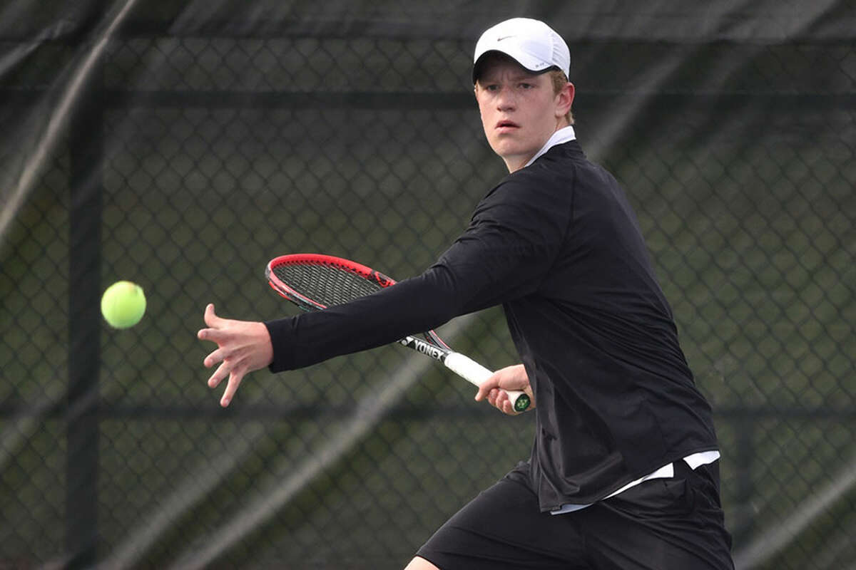 New Canaan’s Matt Brand lines up a forehand shot during a boys tennis match against Darien at the New Canaan High School courts on April 29, 2019. — Dave Stewart/Hearst Connecticut Media