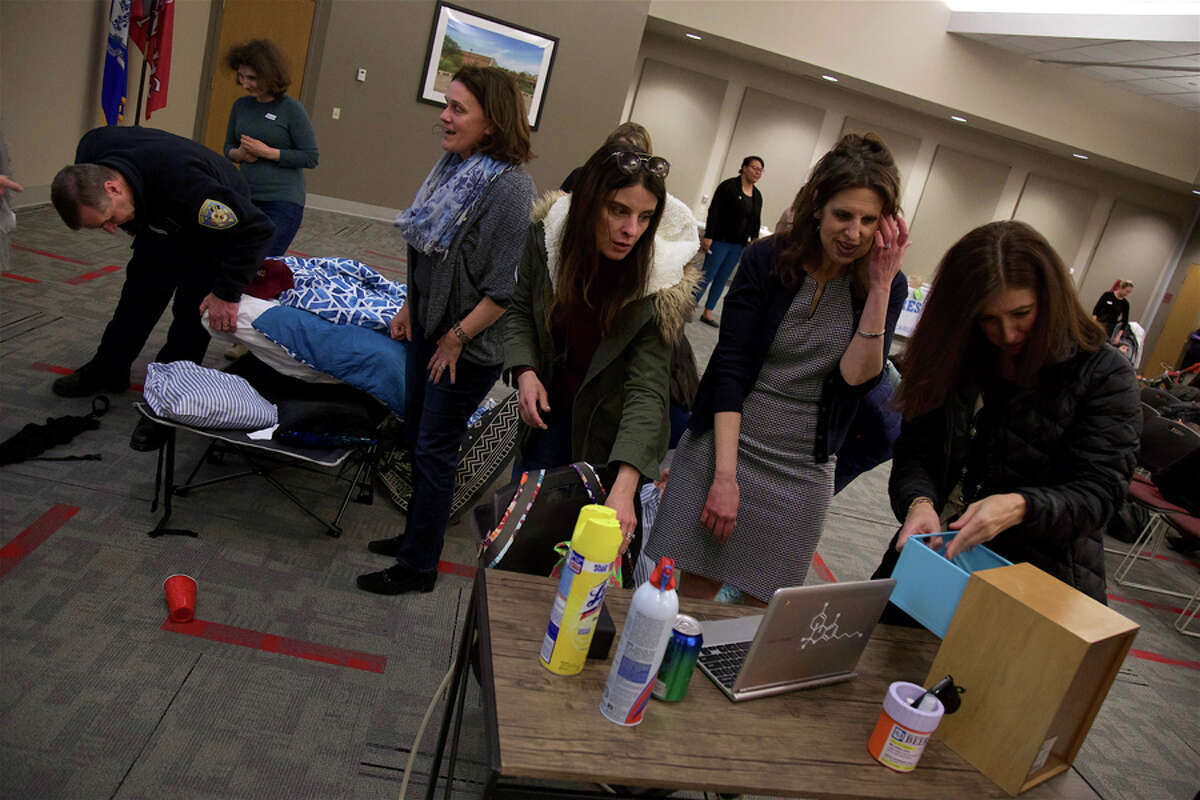 Signs of substance abuse are Hiding in Plain Sight. Parents search the mock bedroom for secrets in a demo at New Canaan High School Tuesday, March 26, learning how teens can easily hide evidence of substance abuse. — Jarret Liotta / For Hearst Connecticut Media